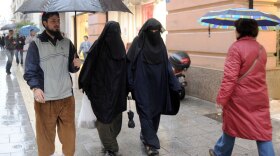 Two veiled Muslim women walk down a street in Marseille, in southern France.