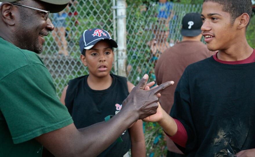 After a disappointing loss, the coach from the opposing team shows Josue Sanchez a new handshake as Angel Ramirez watches.