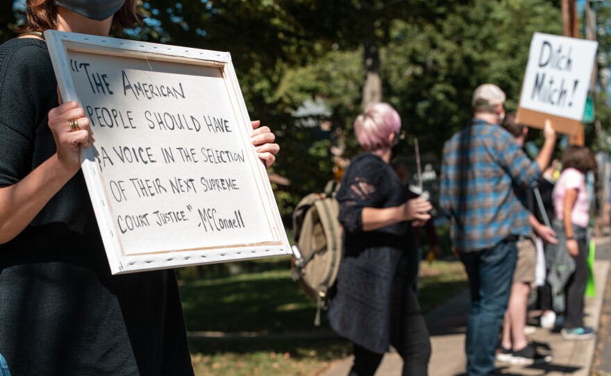 Protesters rally in front of Senate Majority Leader Mitch McConnell's home in Louisville, Ky., on Sunday. Soon after Justice Ruth Bader Ginsburg's death, McConnell said President Trump's court nominee will receive a vote in the Senate.