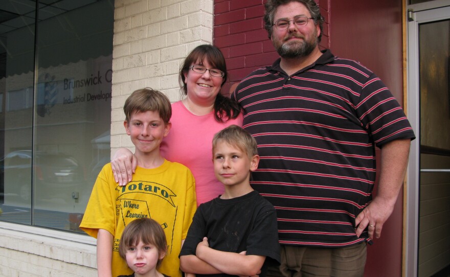 Emily and Derek Lewis and their children (from bottom left) Miranda, 3, Rhys, 10, and Alistair, 8. The Lewis' live next to Saint Paul's College, and the notion of immigrant teens being housed there makes them uneasy.