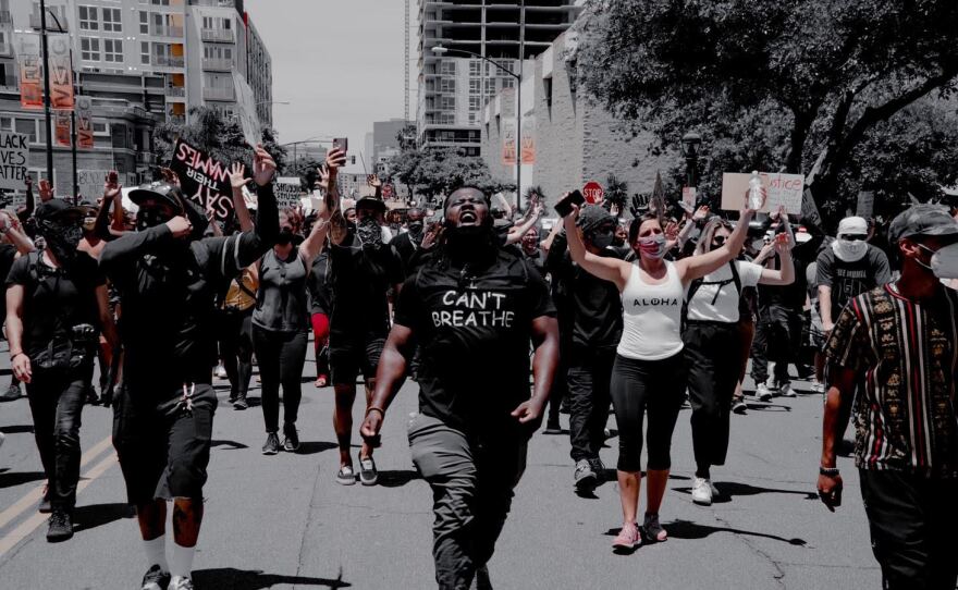 Joshua Williams, middle, participates in protest in downtown San Diego, May 31, 2020.