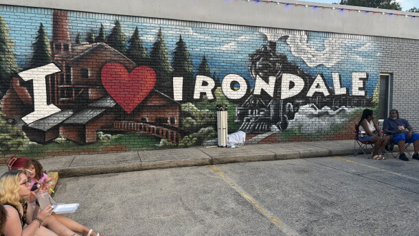 Festival-goers sit outside Irondale, Alabama's city hall on I Love Irondale Day, July 18, 2026.