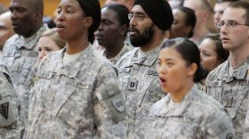 U.S. Army Capt. Tejdeep Singh Rattan, wearing a turban, stands with other graduates as they sing "The Army Goes Rolling Along" during a U.S. Army officer basic training graduation ceremony at Fort Sam Houston in San Antonio on Monday.