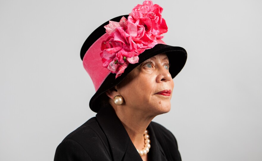 Donna Limerick, daughter of Mae Reeves, wears her favorite hat designed by her mother. The original is housed at the National Museum of African American History and Culture, so she wears a replica.