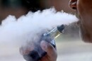 A man exhales while smoking an e-cigarette in Portland, Maine, in this undated file photo.