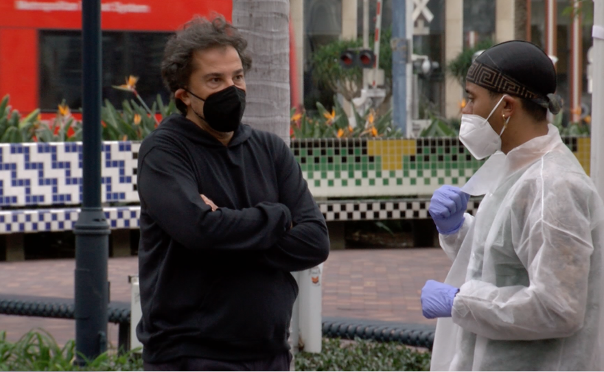 A man speaks to a Broadwell Health testing administrator at the Santa Fe Transit Station in downtown San Diego, Jan. 10, 2022.