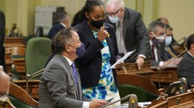 Assemblywoman Akilah Weber, D-San Diego, talks with Assemblyman Phil Ting, D-San Francisco, as the Assembly meets in Sacramento, Calif., Thursday, Sept. 2, 2021