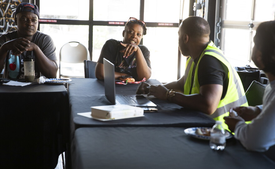 Latara Sutton shares her thoughts during the weekly IMAN organizing committee meeting on July 8 in Chicago.