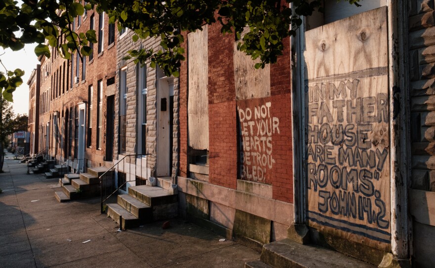 Vacant rowhouses line a portion of Franklin Square, a formerly redlined neighborhood in Baltimore. New research shows many communities subjected to discriminatory housing practices in the 1930s are hotter today.