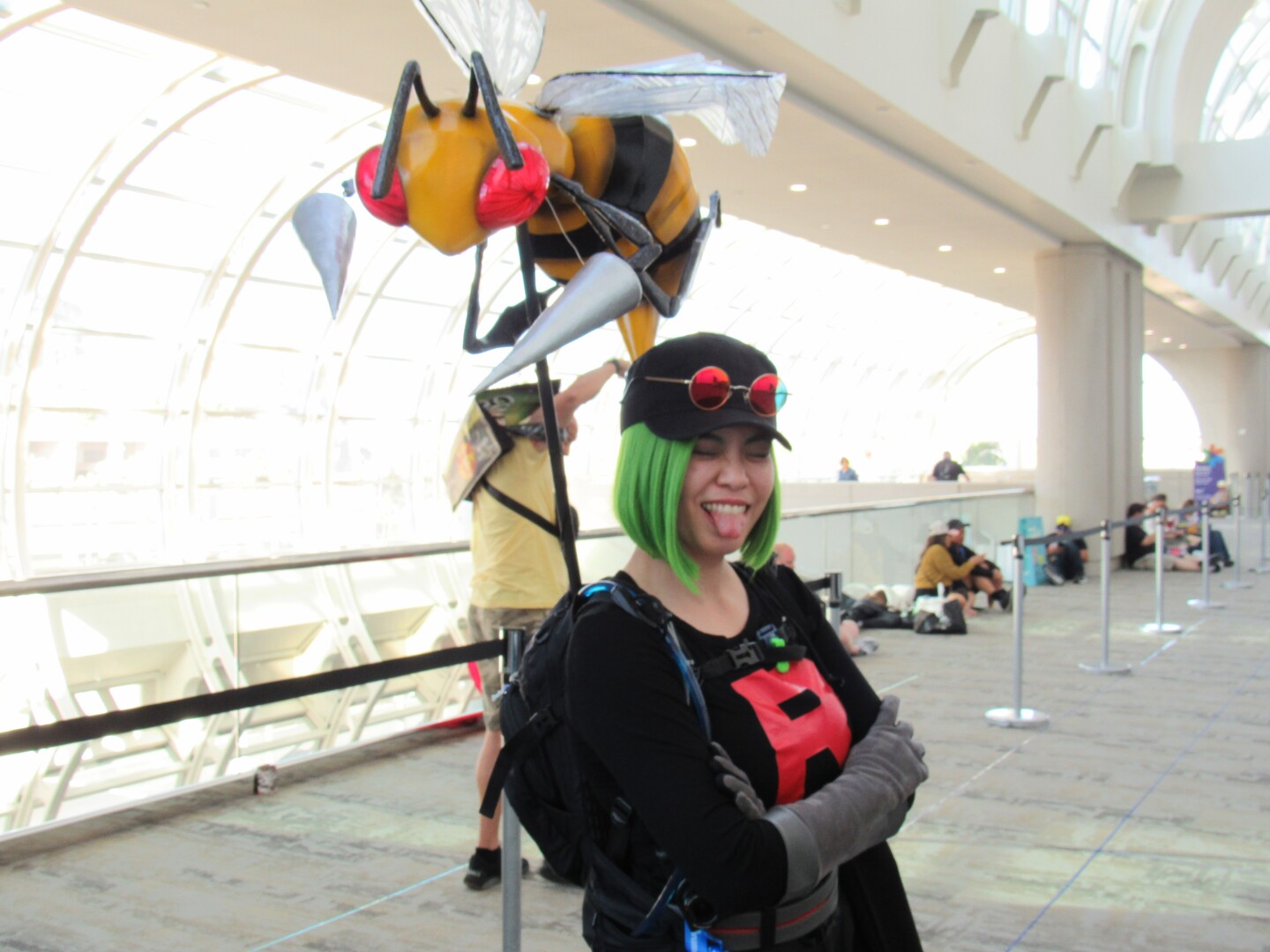 Cathy Yee poses as a Team Rocket thug from the video game–turned–anime "Pokémon," with her handmade Beedrill companion over her shoulder on July 25, 2025.