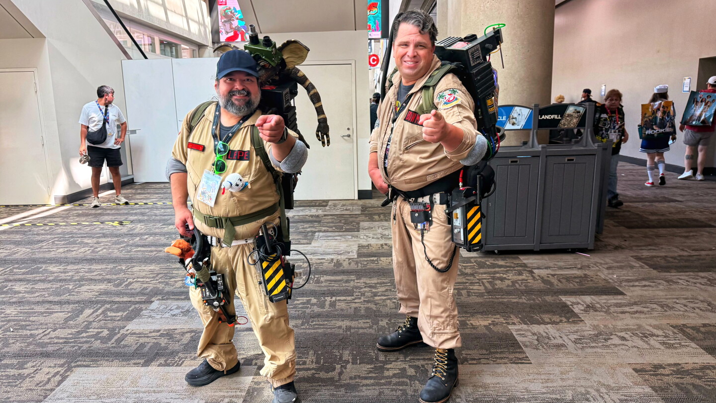 Two Ghostbusters pose with their proton packs at Comic-Con on July 26, 2026.