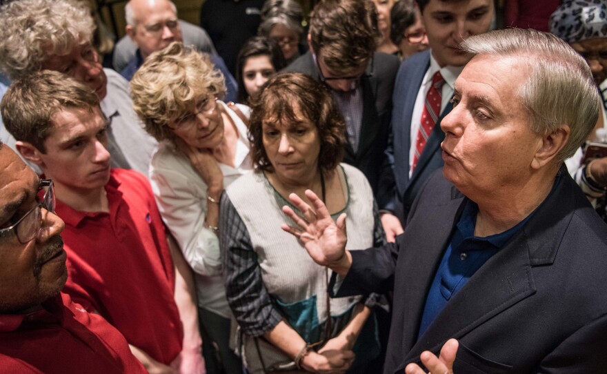 Sen. Lindsey Graham talks with constituents after a town hall meeting today in Columbia, S.C. Protestors have been showing up in large numbers to congressional town hall meetings across the nation.