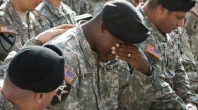 A soldier cries at a memorial service at Fort Hood, Texas, for the victims of the shootings at the Army post.