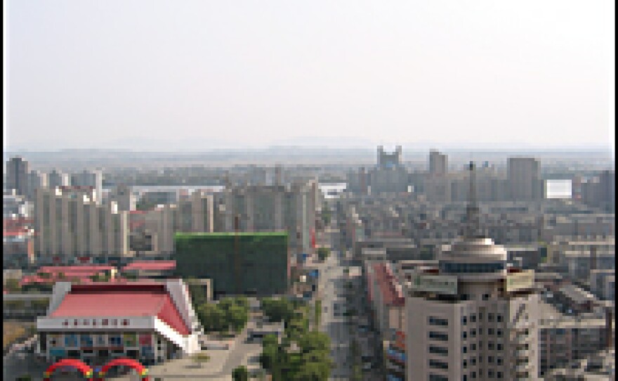 The view looking east through the Chinese border city of Dandong, across the Yalu River and into the North Korean City of Sinuiju.