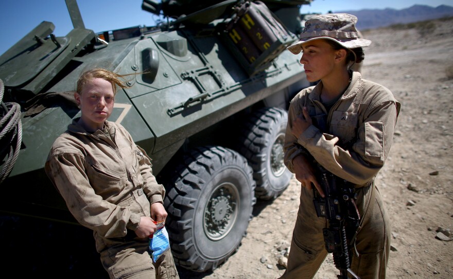 Lance Cpl. Brittany Holloway (left) talks Brittany Dunklee next to their LAV.