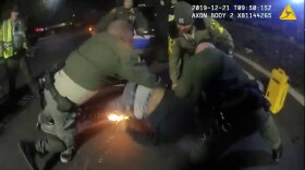 A screenshot of body camera footage released by the San Diego County Sheriff's Department that shows deputies subduing Joe Young on Dec. 21, 2019. Young was tased three times and the taser ignited a lighter in his pocket started a fire. Young was later treated for his injuries at a hospital and the charges against him were dismissed.