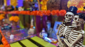 Two embracing skeletons sit on an altar at the Sherman Heights Community Center on Oct. 15, 2025