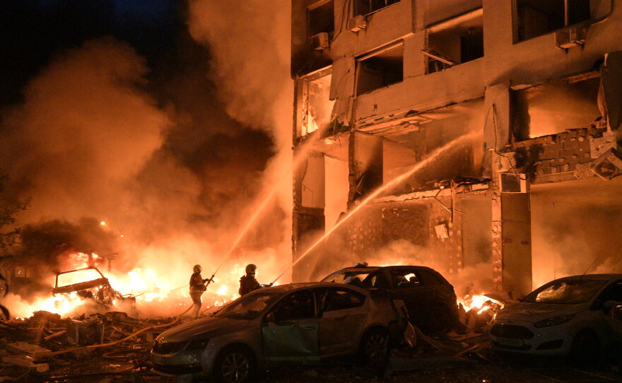 Emergency services personnel work to extinguish a fire following Russian missile attacks in Kyiv, Ukraine, Monday, July 6, 2026.