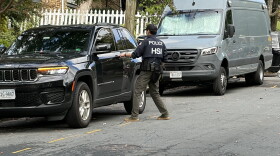 A Homeland Security Investigations agent gets in a car outside the Washington, D.C. residence of Rep. Ilhan Omar, D-Minn., on Monday morning.