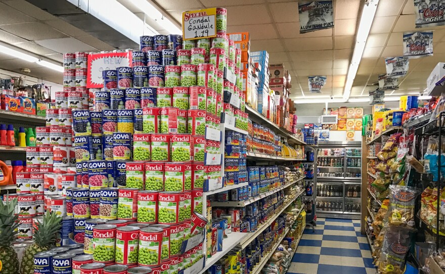 Canned beans and bags of rice line an aisle at A & M Supermarket, a large bodega in the Bronx.