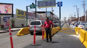 A tourism official stands in front of the new designated medical tourism lane at the Mexicali border crossing.