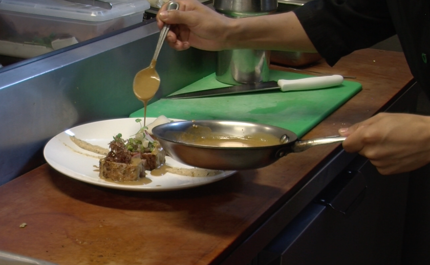 A cook prepares seared tuna at Misión 19 in Tijuana, June 3, 2015.