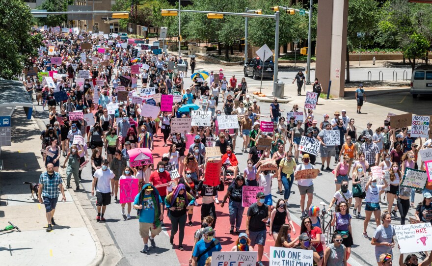 Protesters march down Lavaca Street at a protest outside the Texas state capitol on May 29, 2021 in Austin, Texas. Thousands of protesters came out in response to a new bill outlawing abortions after a fetal heartbeat is detected signed on Wednesday by Texas Governor Greg Abbot.