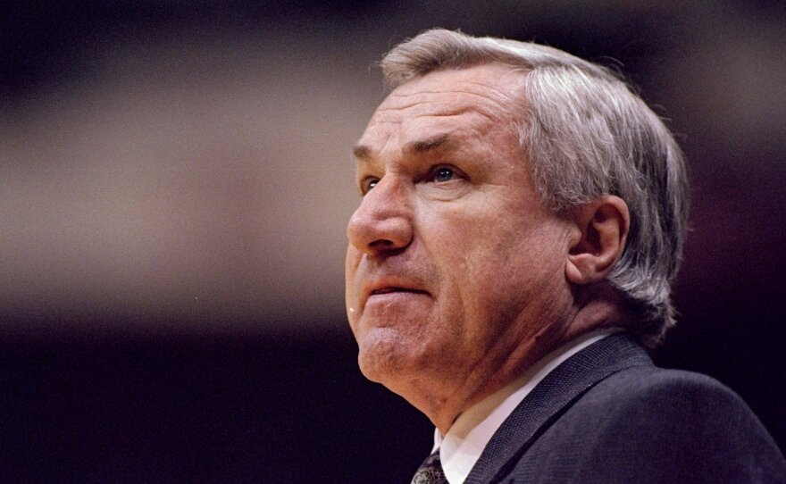 Former UNC head coach Dean Smith of the North Carolina Tar Heels looks on during a NCAA Tournament game against the Texas Tech Red Raiders in 1996. Smith died on Sunday. He was 83.