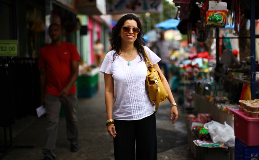 Rosario Rivera is an economist and professor at the University of Puerto Rico. She lives on the island with her husband, a lawyer, but they've considered moving to the mainland. She is seen here at a street market in the Rio Piedras neighborhood of San Juan.