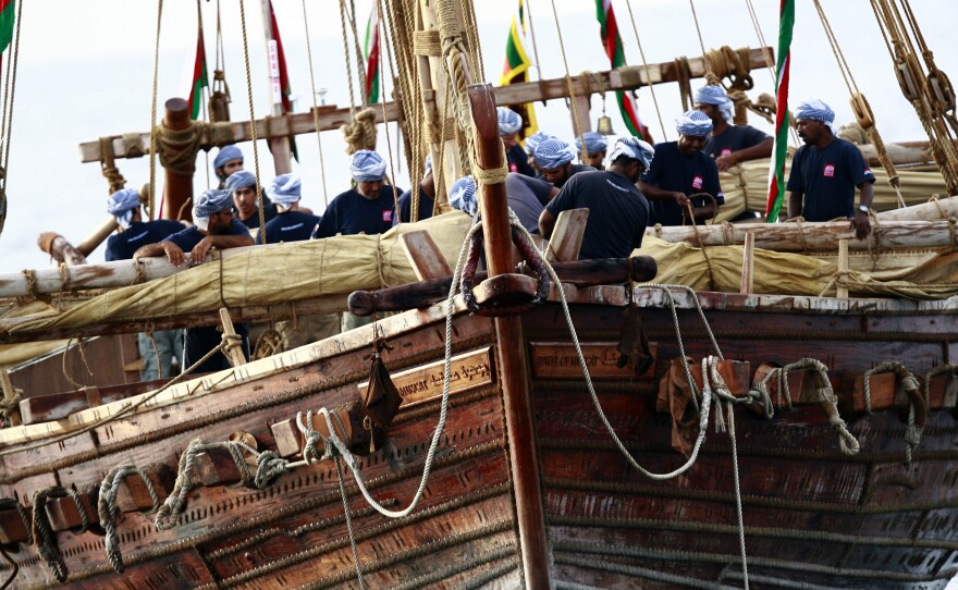 The crew of the Jewel of Muscat, a 9th-century replica of an Omani trading ship, folds its main sails as it enters into the harbor of Galle, Sri Lanka in 2010.