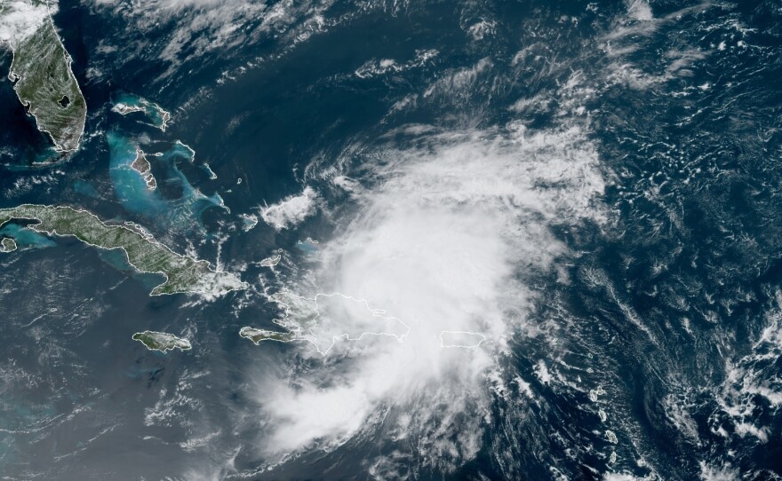 A satellite image from Thursday morning shows Tropical Storm Isaias looming over Puerto Rico and the Dominican Republic. The storm is predicted to drench Florida over the weekend.