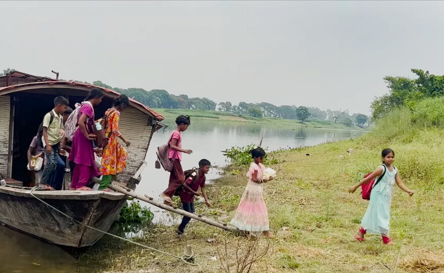 Students head home after class ends at the floating school.
