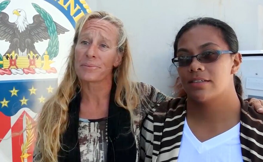 Jennifer Appel (left) and Tasha Fuiava are interviewed aboard the USS Ashland in the South Pacific on Oct. 25. They were rescued after reportedly drifting for months while trying to sail from Hawaii to Tahiti.