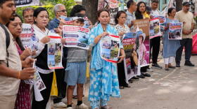 Relatives of recent flash flood victims hold banners urging authorities to step up efforts to find their missing loved ones during a demonstration in Kathmandu, Nepal, on Monday.