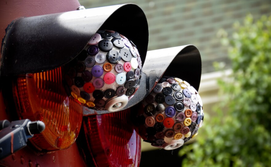Button-craft disco balls dangle on the bus, capturing the whimsical spirit of the tour and its guide.