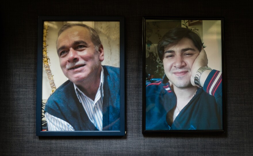 Photos of Mahmoud's husband, Abdelaziz al-Khair (left), and son hang in her apartment in Berlin. For her, the international arrest warrants for top Syrian officials brought some relief.