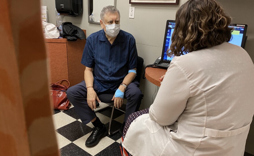Ed Hollingsworth listens to a medical professional while sitting in an examination room at UC San Diego's Moores Cancer Center, Jan. 16, 2020.