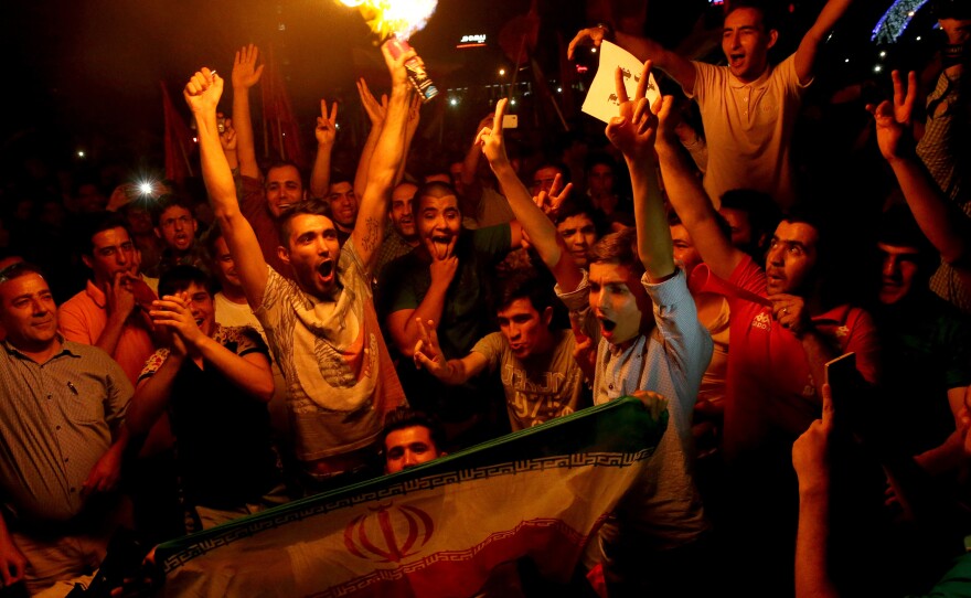Iranians cheer during street celebrations July 14 in Tehran, Iran, following a landmark nuclear deal. Many young Iranians want their country to open to the world, and see the nuclear agreement as an important step in ending Iran's isolation.