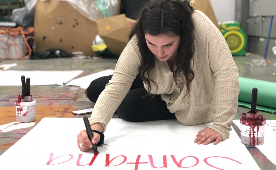 Patrick Henry High School senior Maya Klareich, 17, makes a sign for a school walkout, March 12, 2018.