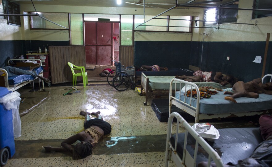 Two people lay dead on the floor inside the critical ward of the Redemption Hospital, which has become a transfer and holding center to intake Ebola patients located in one of the poorest neighborhoods of Monrovia.