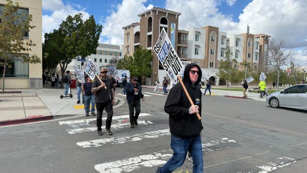 Members of the Teamsters Union Local 2010 are shown walking a picket line at San Diego State University on February 17, 2026.