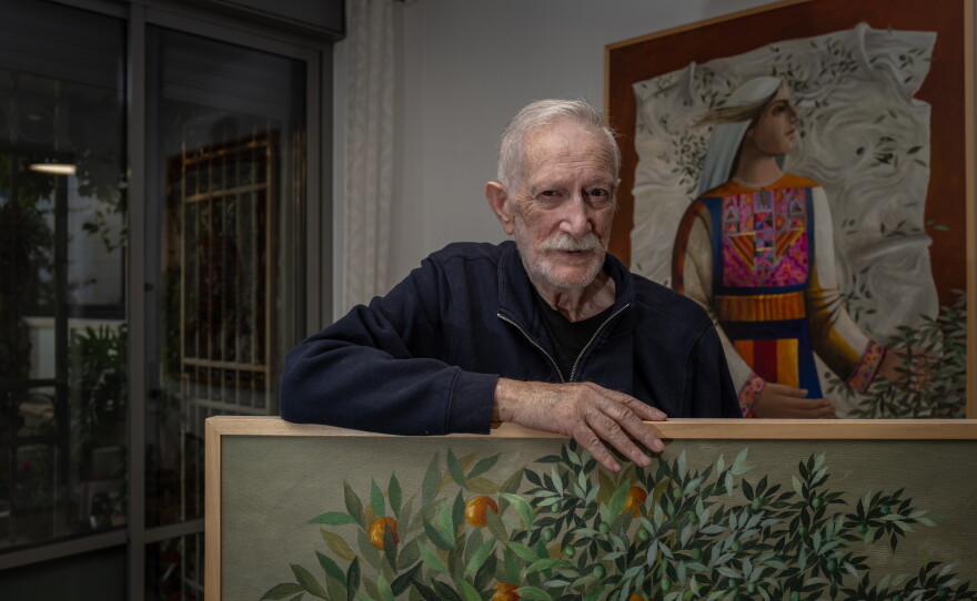 Palestinian artist Sliman Mansour at his home in Jerusalem, surrounded by his paintings on Nov. 18, 2025.