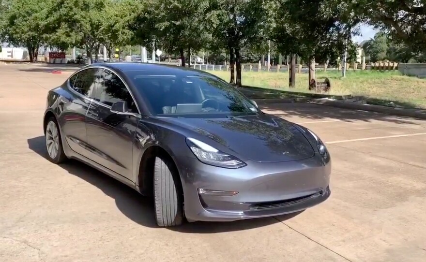 A Tesla 3 model is remotely driven with the company's phone app in Austin, Texas, in this still image taken from social media video.