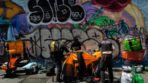 Michael Johnson takes down his tent in downtown San Francisco with the help of activists on Aug. 9, 2024.
