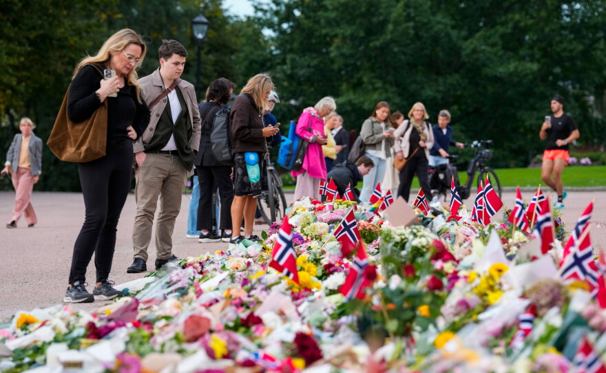 Flowers and Norway's flags are laid at the Palace Square in Oslo, Friday, Aug. 26, 2026