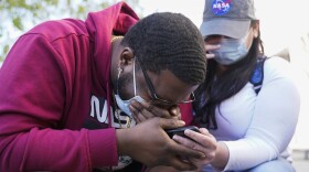 London Williams, 31, of Harrisburg, Pa., bursts into tears on Tuesday, April 20, 2021, in Washington, after hearing that former Minneapolis police Officer Derek Chauvin was convicted of murder and manslaughter in the death of George Floyd. 