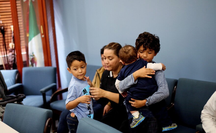 A family waits before a class for new student arrivals to Mexico at the Tijuana Education Department in Tijuana, Mexico.