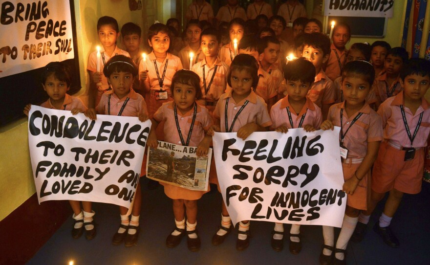 Indian school children hold candles and prayer messages for those killed in the crash of a Malaysia Airlines plane carrying 298 people from Amsterdam to Kuala Lumpur.