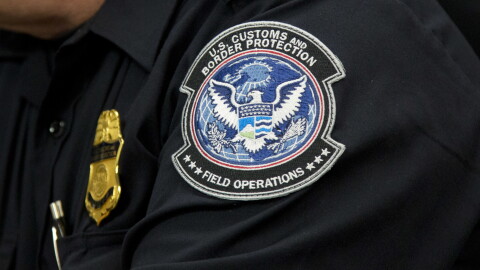 A customs agent wears a patch for the U.S. Customs and Border Protection agency, Friday, Oct. 27, 2017. 
