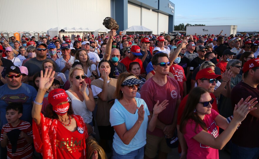 Supporters cheer during a Trump rally in Pensacola, Fla. Rallies and in-person events have been a key part of the campaign strategy, even in the midst of the pandemic.